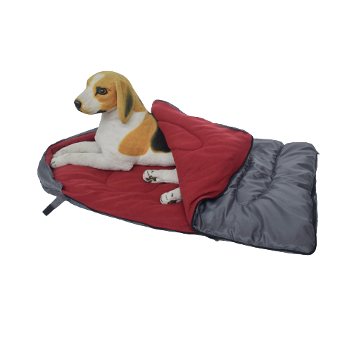 Happy dog lounging in durable wine red pet bed outdoors, ideal for hiking with pets.
